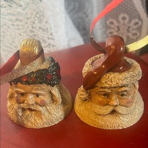 Two resin Santa head ornaments